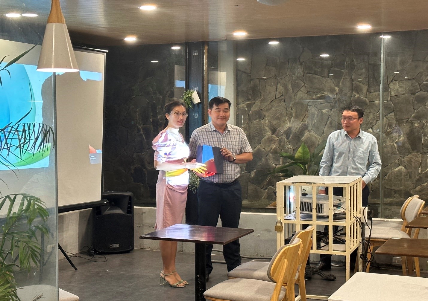 A group of people standing around a tableDescription automatically generated